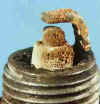 Spark plug with ash deposits